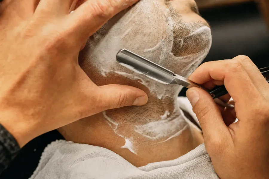 Hot-lather straight-razor shave close-up
